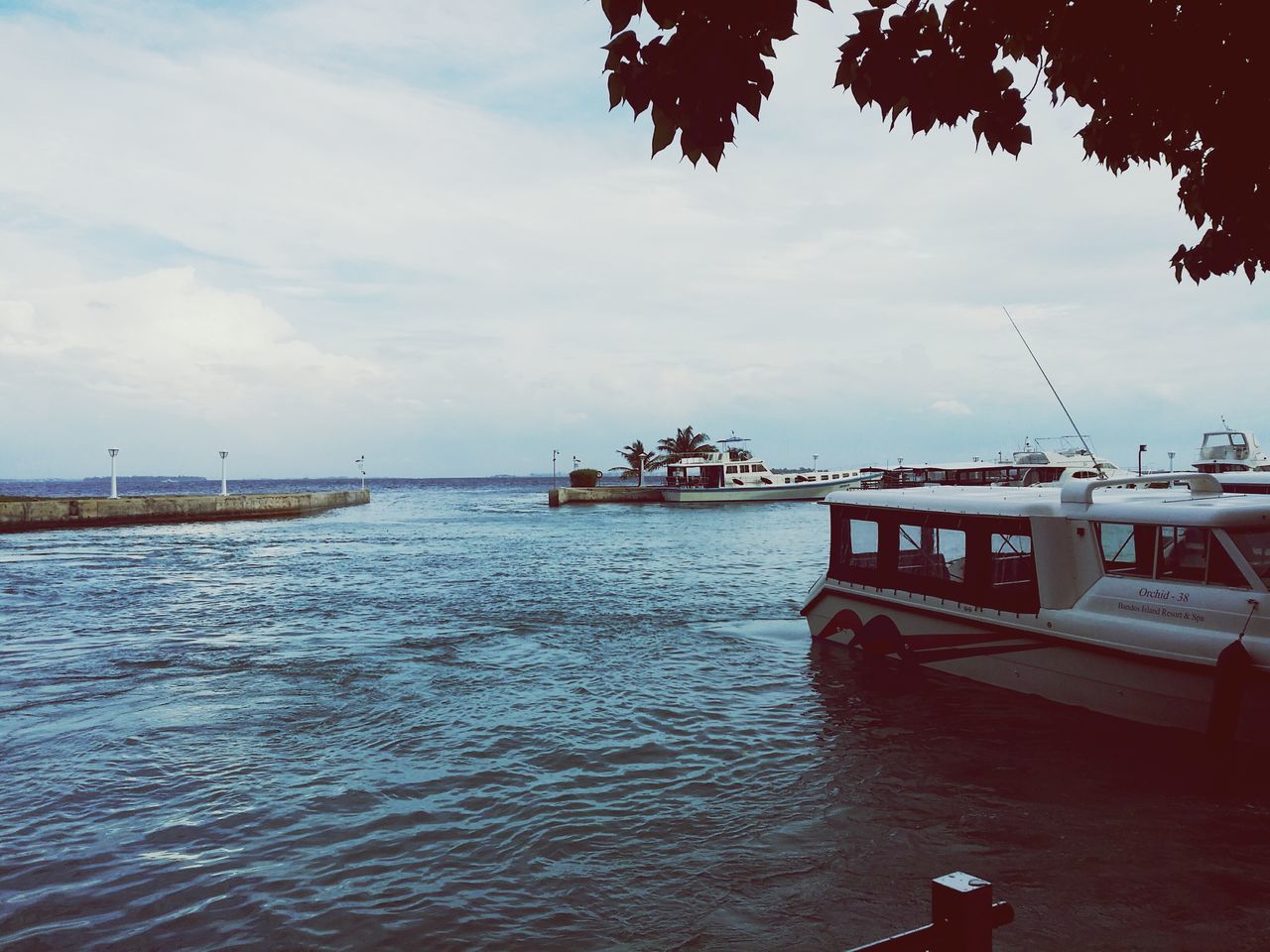 water, sky, cloud - sky, nautical vessel, sea, pier, boat, cloud, built structure, waterfront, nature, transportation, cloudy, incidental people, rippled, tranquility, outdoors, tranquil scene, mode of transport