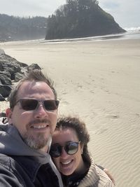 Portrait of man wearing sunglasses at beach