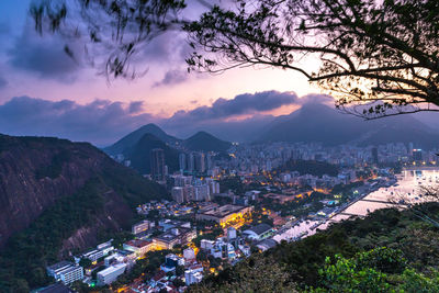 High angle view of buildings and trees against sky at sunset