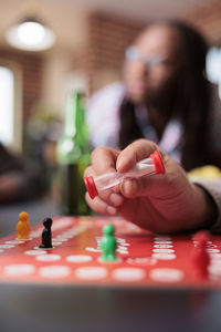 Cropped hand of woman playing chess