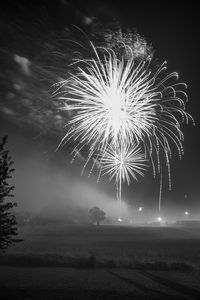 Low angle view of firework display at night