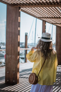 Rear view of woman looking at camera