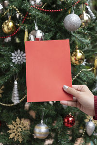 Close-up of hand holding christmas tree
