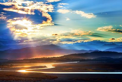 Scenic view of dramatic sky over landscape during sunset