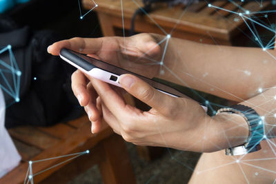 Midsection of man using mobile phone