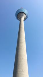 Low angle view of tower against blue sky