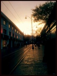 View of street in city at sunset