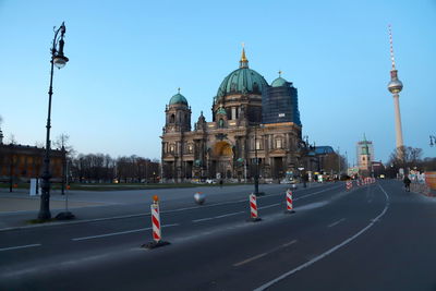 View of city street and buildings against sky