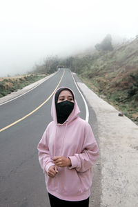 Portrait of man standing on road