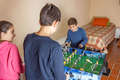 Kids playing table soccer at home