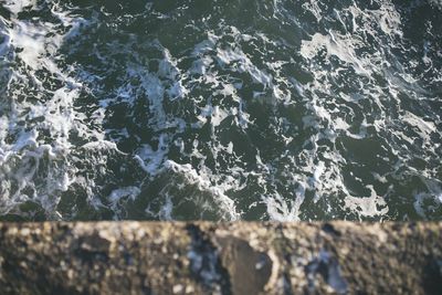 High angle view of rocks in sea