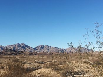 Scenic view of mountains against clear blue sky