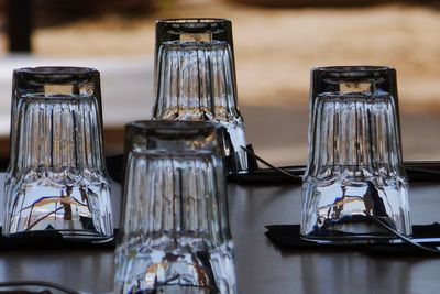 Upside down image of drinking glasses arranged on table at restaurant