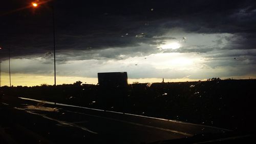 Road against cloudy sky at dusk