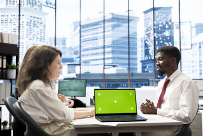 Young man using laptop at office