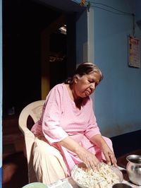 Woman sitting on table