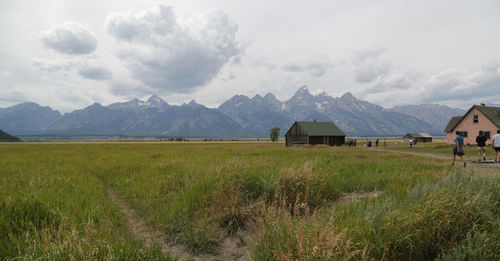 Scenic view of field and mountains against sky