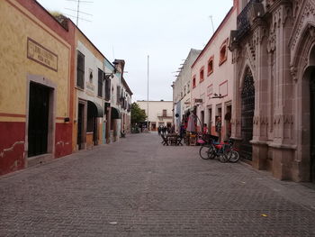 Street amidst buildings in city against sky