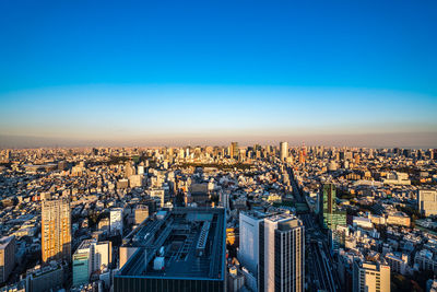 High angle view of modern buildings against clear blue sky