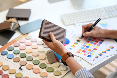 Cropped hands of man working on table