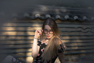 Woman standing against wall