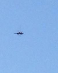 Low angle view of airplane flying against clear blue sky