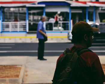 Man standing at railroad station platform