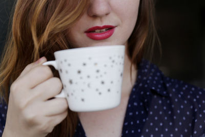 Close-up woman holding coffee cup