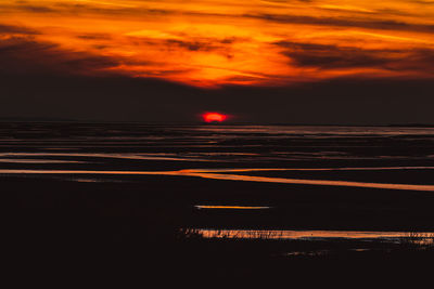 Scenic view of sea against romantic sky at sunset