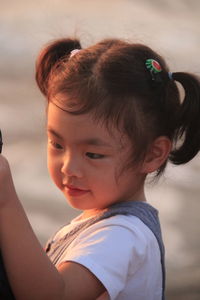 Close-up portrait of cute girl looking away