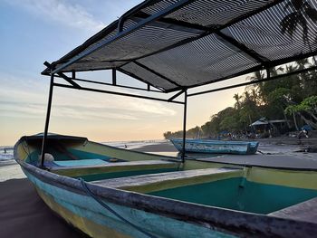 Swimming pool by sea against sky during sunset