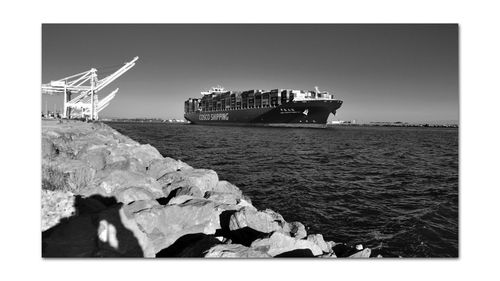 Ship sailing on sea against clear sky