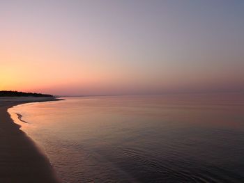 Scenic view of sea against clear sky during sunset