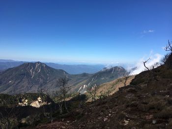 Scenic view of mountains against clear blue sky