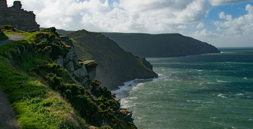 Scenic view of sea and mountains against sky