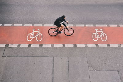 Man riding bicycle on road