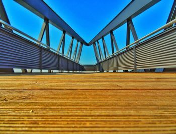 Low angle view of bridge against clear blue sky