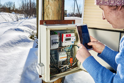 Close-up of man working on snow