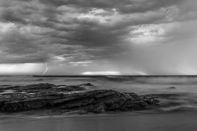 Scenic view of sea against cloudy sky