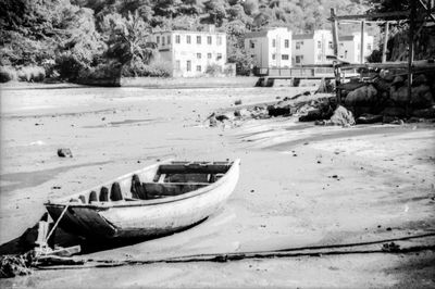 Abandoned boats moored on beach