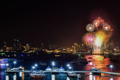 Firework display over river at night