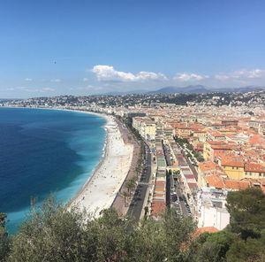 High angle view of cityscape by sea against sky