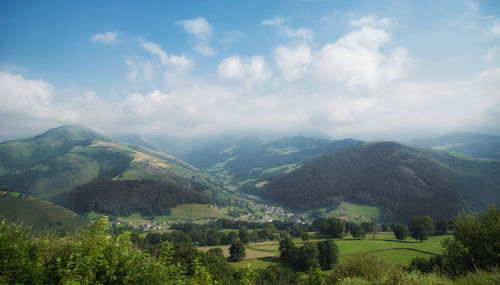 Scenic view of landscape and mountains against sky