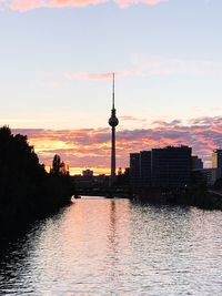 City at waterfront during sunset
