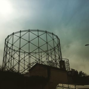 Low angle view of silhouette building against sky