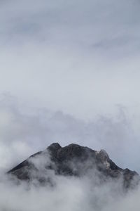 Low angle view of volcanic mountain against sky