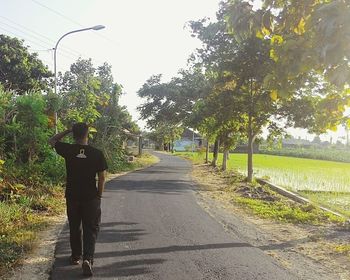 Woman walking on footpath