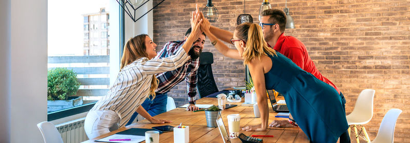 Businesspeople celebrating a success high-fiving