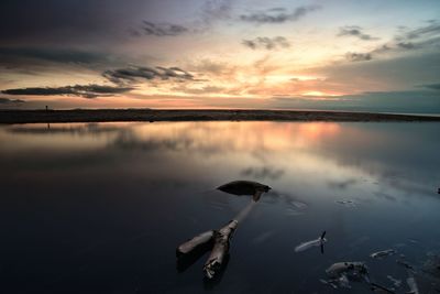 Scenic view of lake against sky during sunset