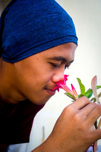 Close-up portrait of boy holding flower head